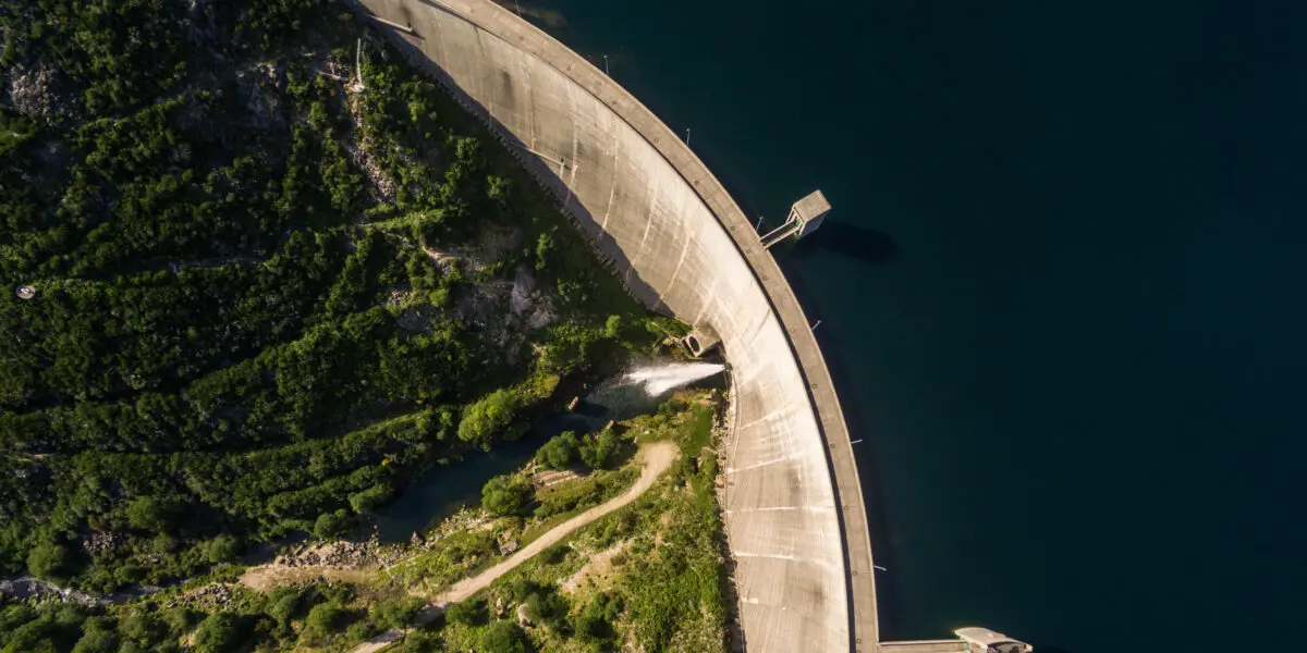 Aerial view of the Vilarinho da Furna dam in the sunshine, surrounded by impressive nature.