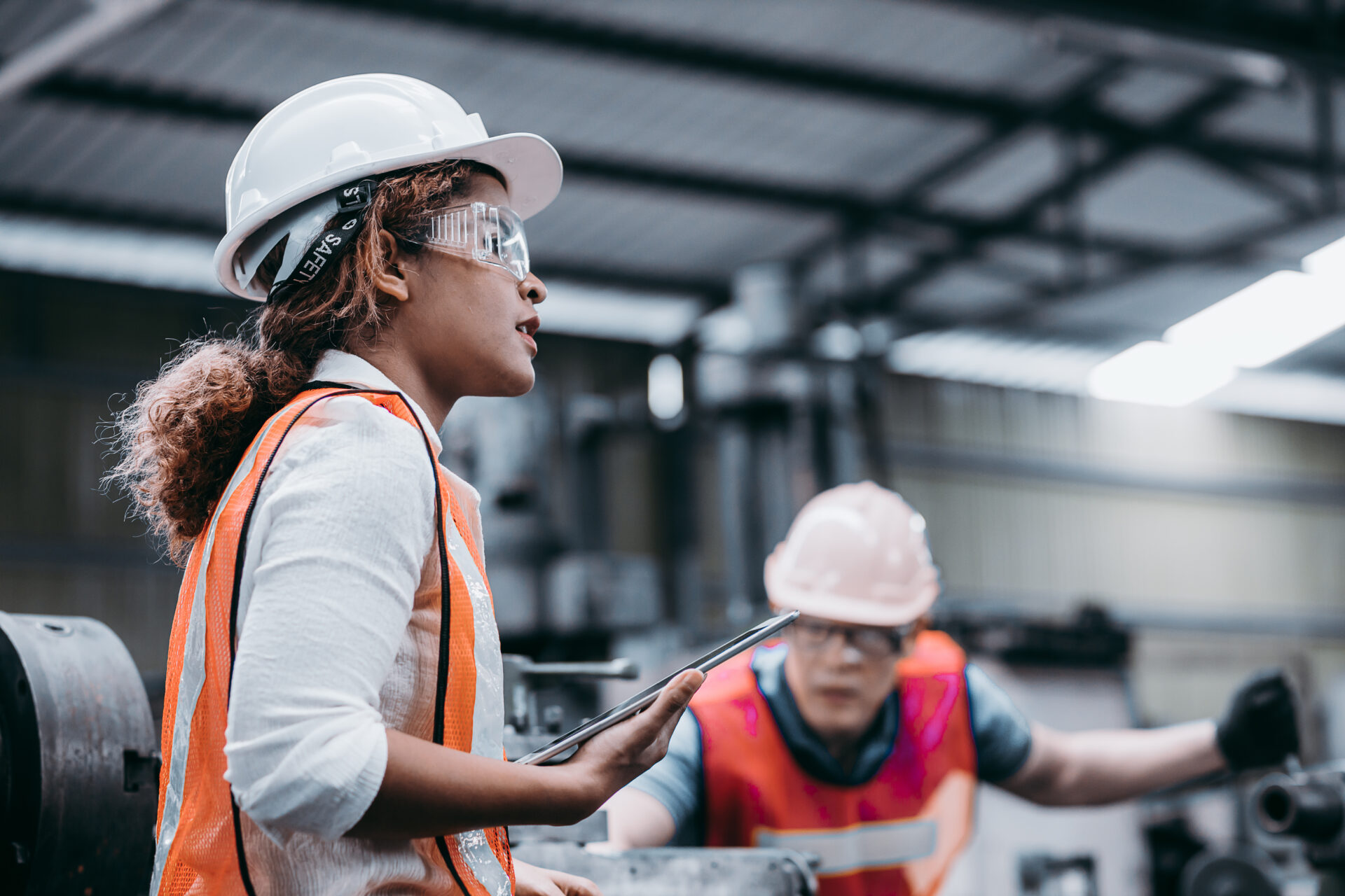 Female industrial engineer wearing a white helmet while standing