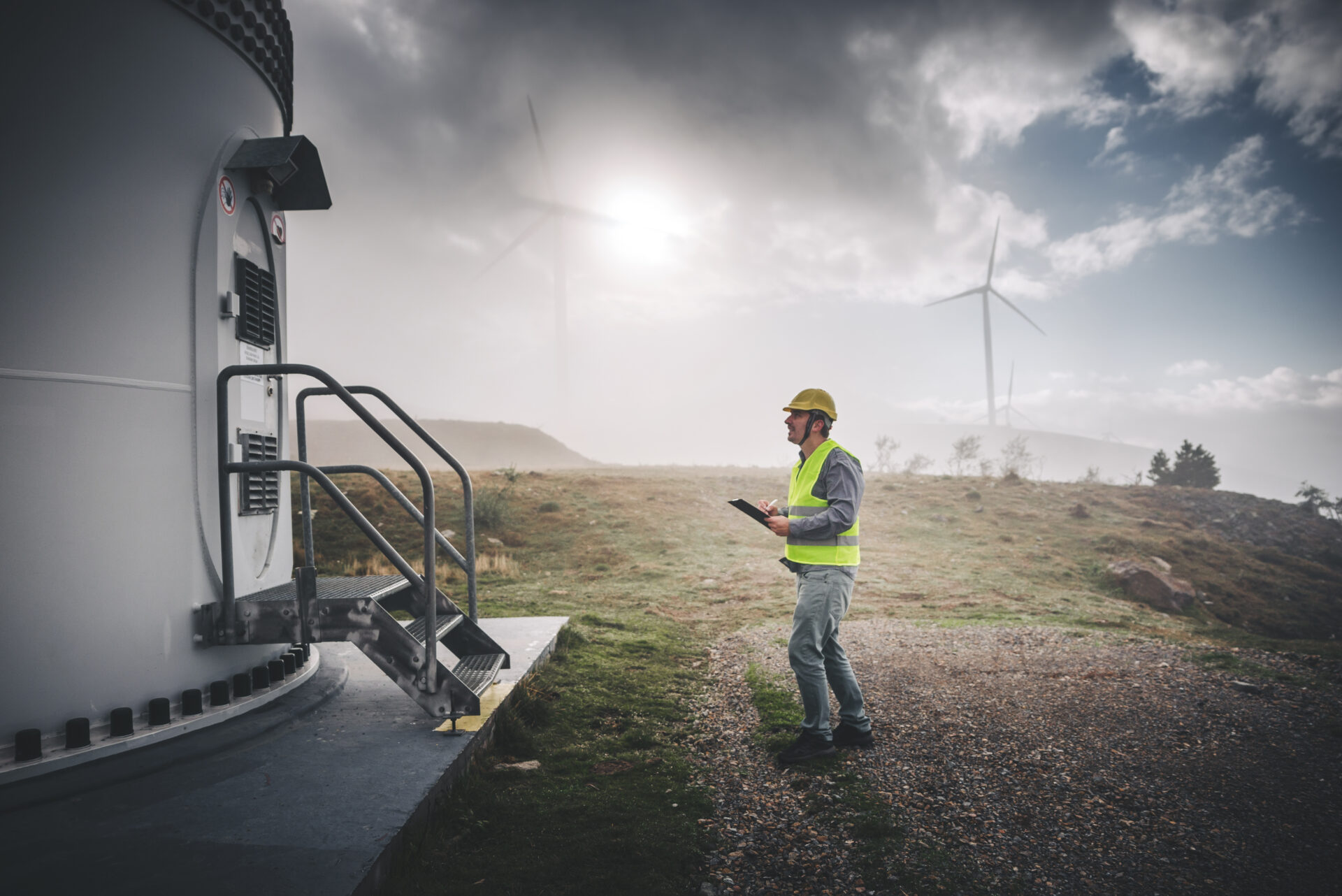 Young engineer man looking and checking wind turbines