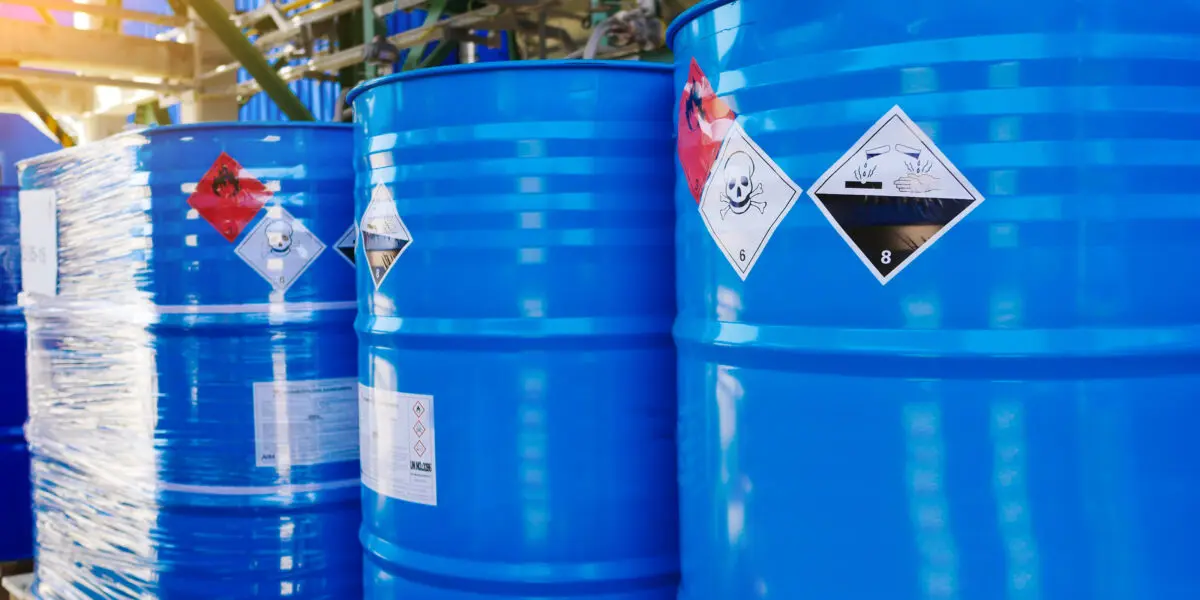 Warning signs for flammable, acid and volatile substances on storage tanks of a chemical industrial plant.