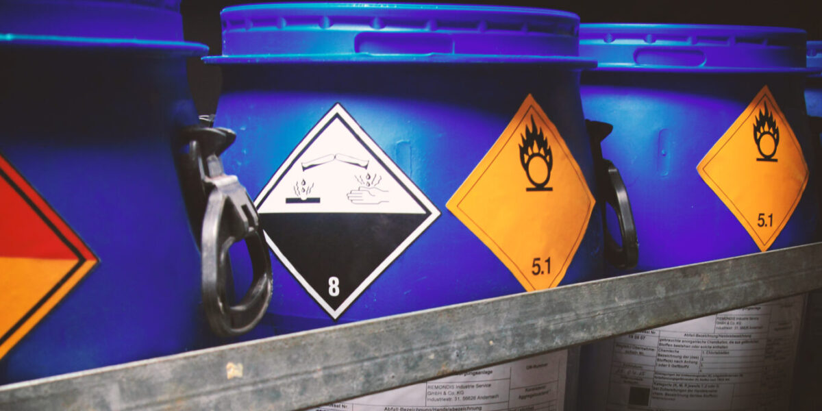 Hazardous goods containers with hazardous goods labels for flammable, oxidising and corrosive substances.